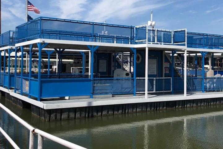 a blue boat docked next to a body of water