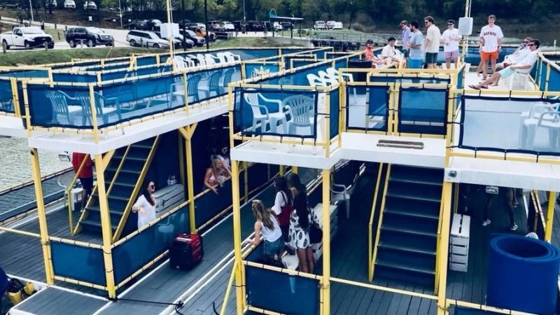 a blue and yellow boat sitting in a harbor