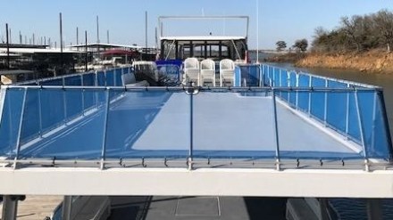 a blue and white boat parked at a dock