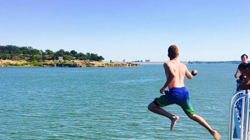 a man riding a board on a body of water