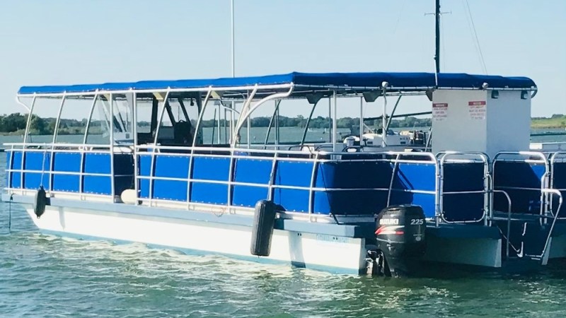 a boat is docked next to a body of water