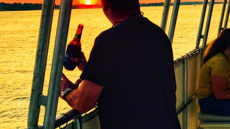 a man standing in front of a pier