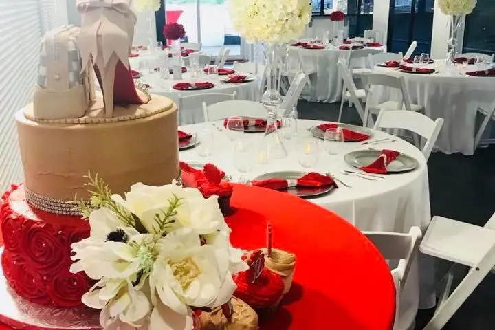 a group of people sitting at a red table with food