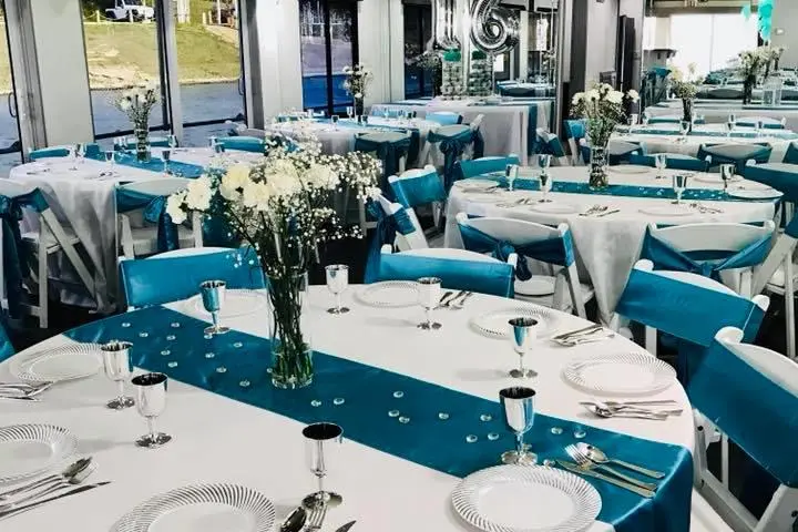 a group of people sitting at a table with a blue chair