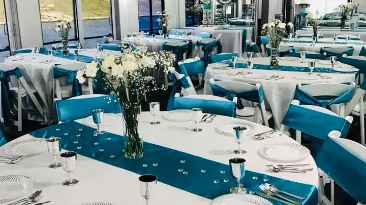 a group of people sitting at a table with a blue chair