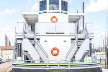 a boat is docked next to a body of water