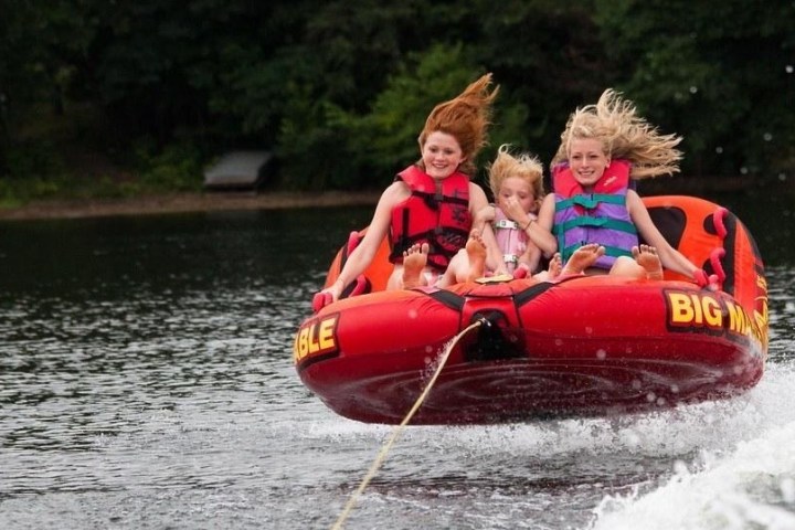 a person riding on the back of a boat in the water