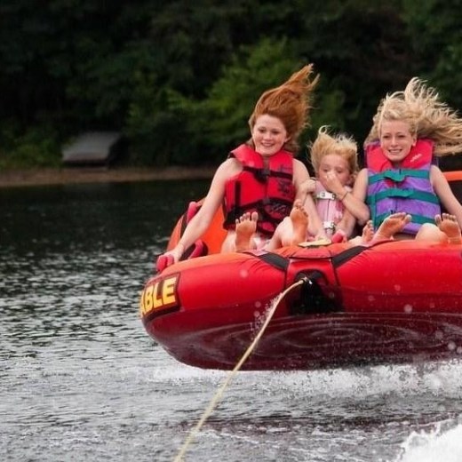a person riding on the back of a boat in the water