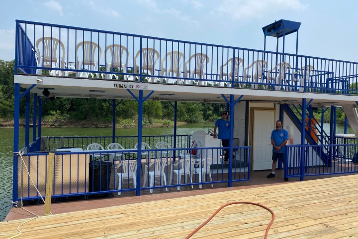 a group of people standing next to a fence