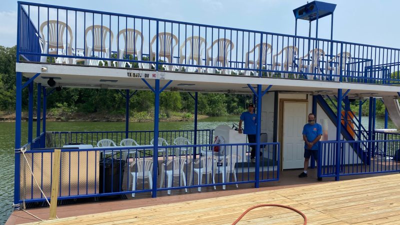 a group of people standing next to a fence