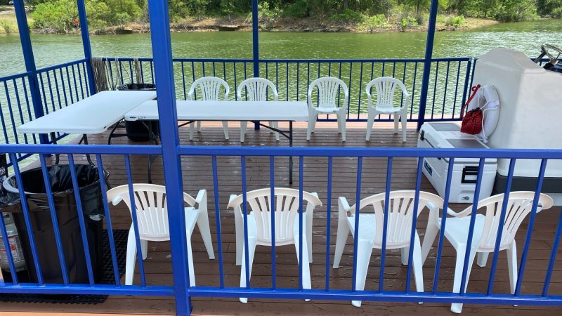 a chair sitting in front of a fence